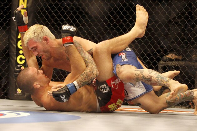 UFC Lightweight Kurt Pellerino, top, and Josh Neer battle in the first round of their mixed martial arts match, Saturday, Aug. 8, 2009, in Philadelphia. (AP Photo/H. Rumph Jr)