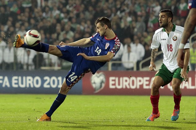 Croatia's Marcelo Brozovic, left, tries to score next to Bulgaria's Nikolay Gadzhev, during their Euro 2016 group H qualifying soccer match at Vassil Levski stadium in Sofia, Friday, Oct. 10, 2014. (AP Photo/Valentina Petrova)