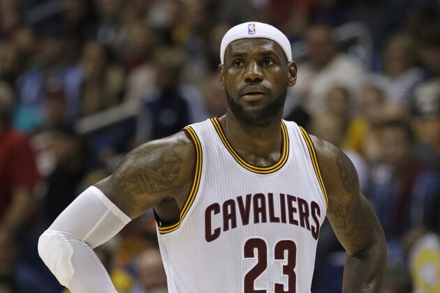 Cleveland Cavaliers forward LeBron James watches during a timeout in the first half of an NBA preseason basketball game against the Indiana Pacers, Wednesday, Oct. 15, 2014, in Cincinnati. (AP Photo/Al Behrman)