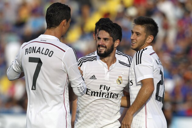 Real Madrid's Isco, center, is congratulated by teammate Cristiano Ronaldo, left, from Portugal after scoring a goal against Levante during a Spanish La Liga soccer match at the Ciutat de Valencia stadium in Valencia, Spain, on Saturday, Oct. 18, 2014. (AP Photo/Alberto Saiz)