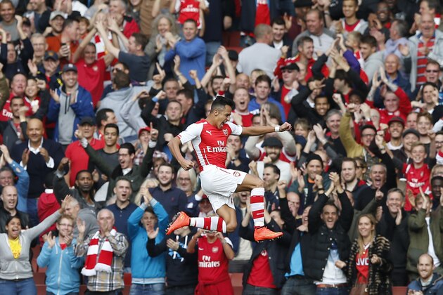 Arsenal's Alexis Sanchez celebrates after scoring the opening goal of the game during the Premier League soccer match between Arsenal and Hull City at the Emirates stadium in London Saturday, Oct.18,  2014. (AP Photo/Alastair Grant)