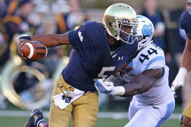 SOUTH BEND, IN - OCTOBER 11:  Everett Golson #5 of the Notre Dame Fighting Irish breaks away from Junior Gnonkonde #44 of the North Carolina Tar Heels at Notre Dame Stadium on October 11, 2014 in South Bend, Indiana. Notre Dame defeated North Carolina 50-43.  (Photo by Jonathan Daniel/Getty Images)