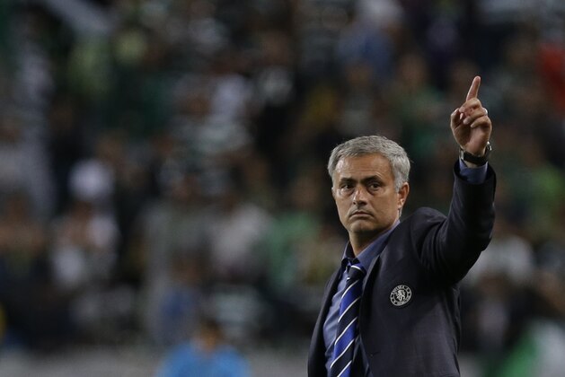 Chelsea's head coach Jose Mourinho celebrates his side's 1-0 win at the end of a Champions League, Group G soccer match between Sporting and Chelsea, in Lisbon, Tuesday, Sept. 30, 2014. (AP Photo/Francisco Seco)