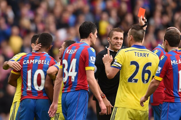 Chelsea’s John Terry confronts the referee as a red card is shown for Chelsea’s Cesar Azpilicueta for a foul on Crystal Palace's Mile Jedinak during their English Premier League soccer match at Selhurst Park, London, Saturday, Oct. 18, 2014. (AP Photo/Tim Ireland)