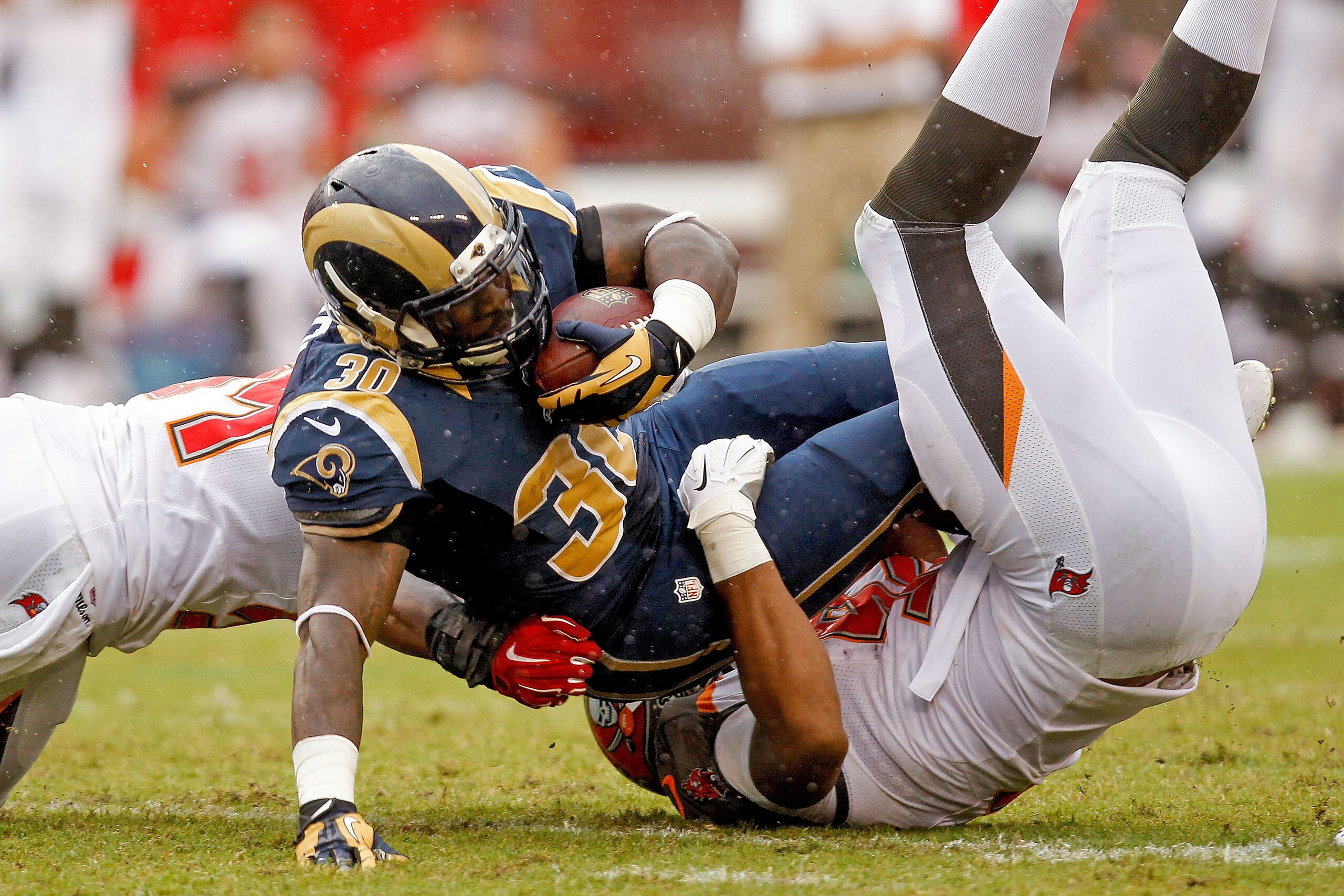 TAMPA, FL - SEPTEMBER 14: Zac Stacy #30 of the St. Louis Rams is tackled by William Gholston #92 of the Tampa Bay Buccaneers during the second quarter of the game at Raymond James Stadium on September 14, 2014 in Tampa, Florida. (Photo by Scott Iskowitz/Getty Images)