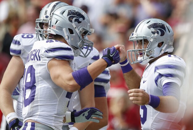 Oct 18, 2014; Norman, OK, USA; Kansas State Wildcats quarterback Jake Waters (15) celebrates with teammates after scoring a touchdown during the game against the Oklahoma Sooners at Gaylord Family - Oklahoma Memorial Stadium. Mandatory Credit: Kevin Jairaj-USA TODAY Sports