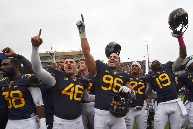 Oct 18, 2014; Morgantown, WV, USA;  West Virginia Mountaineers celebrate on the field after defeating Baylor Bears 41-27 at Milan Puskar Stadium. Mandatory Credit: Tommy Gilligan-USA TODAY Sports