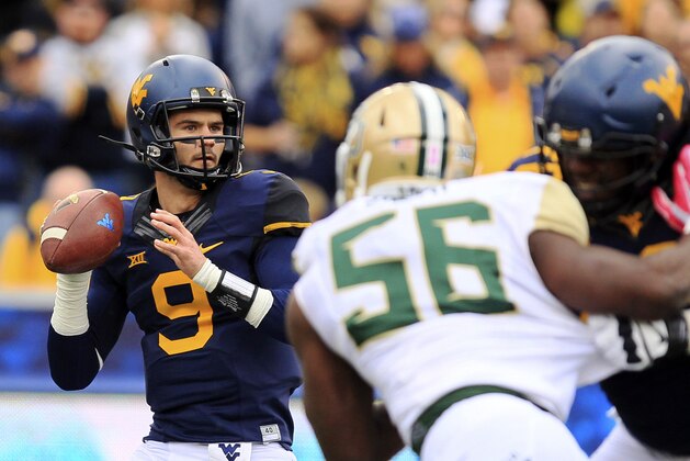 West Virginia quarterback Clint Trickett (9) looks for a receiver during the first quarter of an NCAA college football game against Baylor in Morgantown, W.Va., Saturday, Oct. 18, 2014. West Virginia won 41-27. (AP Photo/Chris Jackson)