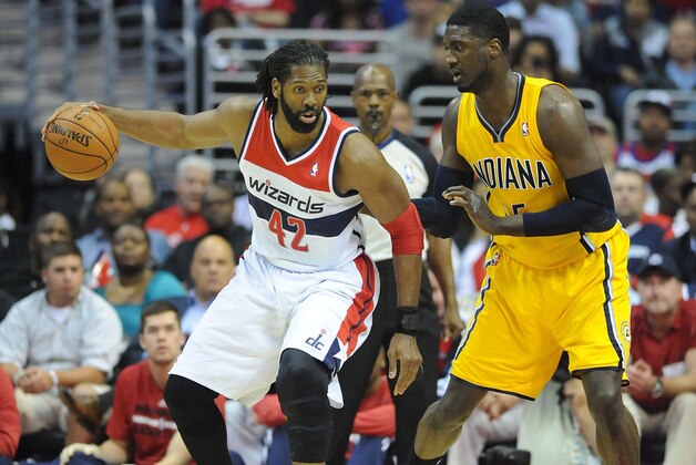 May 9, 2014; Washington, DC, USA; Washington Wizards power forward Nene Hilario (42) dribbles as Indiana Pacers power forward Lavoy Allen (5) defends during the first half in game three of the second round of the 2014 NBA Playoffs at Verizon Center. Mandatory Credit: Brad Mills-USA TODAY Sports