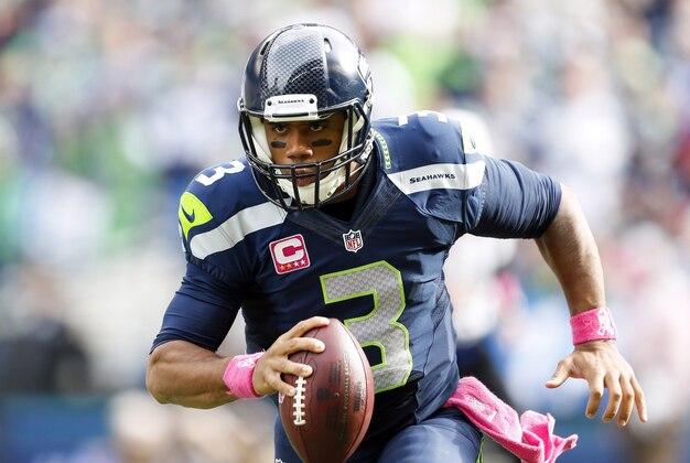 Oct 12, 2014; Seattle, WA, USA; Seattle Seahawks quarterback Russell Wilson (3) rushes against the Dallas Cowboys during the second quarter at CenturyLink Field. Mandatory Credit: Joe Nicholson-USA TODAY Sports