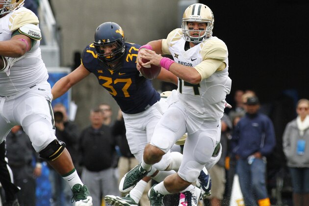 MORGANTOWN, WV - OCTOBER 18:  Bryce Petty #14 of the Baylor Bears rushes against Wes Tonkery #37 of the West Virginia Mountaineers during the game on October 18, 2014 at Mountaineer Field in Morgantown, West Virginia.  (Photo by Justin K. Aller/Getty Images)
