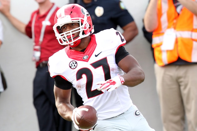 Oct 18, 2014; Little Rock, AR, USA; Georgia Bulldogs running back tailback Nick Chubb (27) rushes for a touchdown during the second quarter against the Arkansas Razorbacks at War Memorial Stadium. Mandatory Credit: Nelson Chenault-USA TODAY Sports