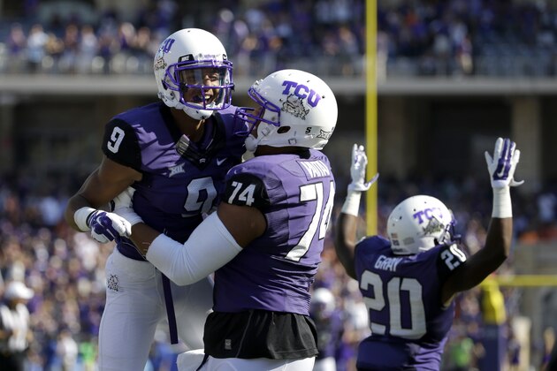 TCU's Josh Doctson (9) celebrates his touchdown with Halapoulivaati Vaitai (74) and Deante' Gray (20) during the first half of an NCAA college football game against Oklahoma State, Saturday, Oct. 18, 2014, in Fort Worth, Texas. (AP Photo/Tony Gutierrez)