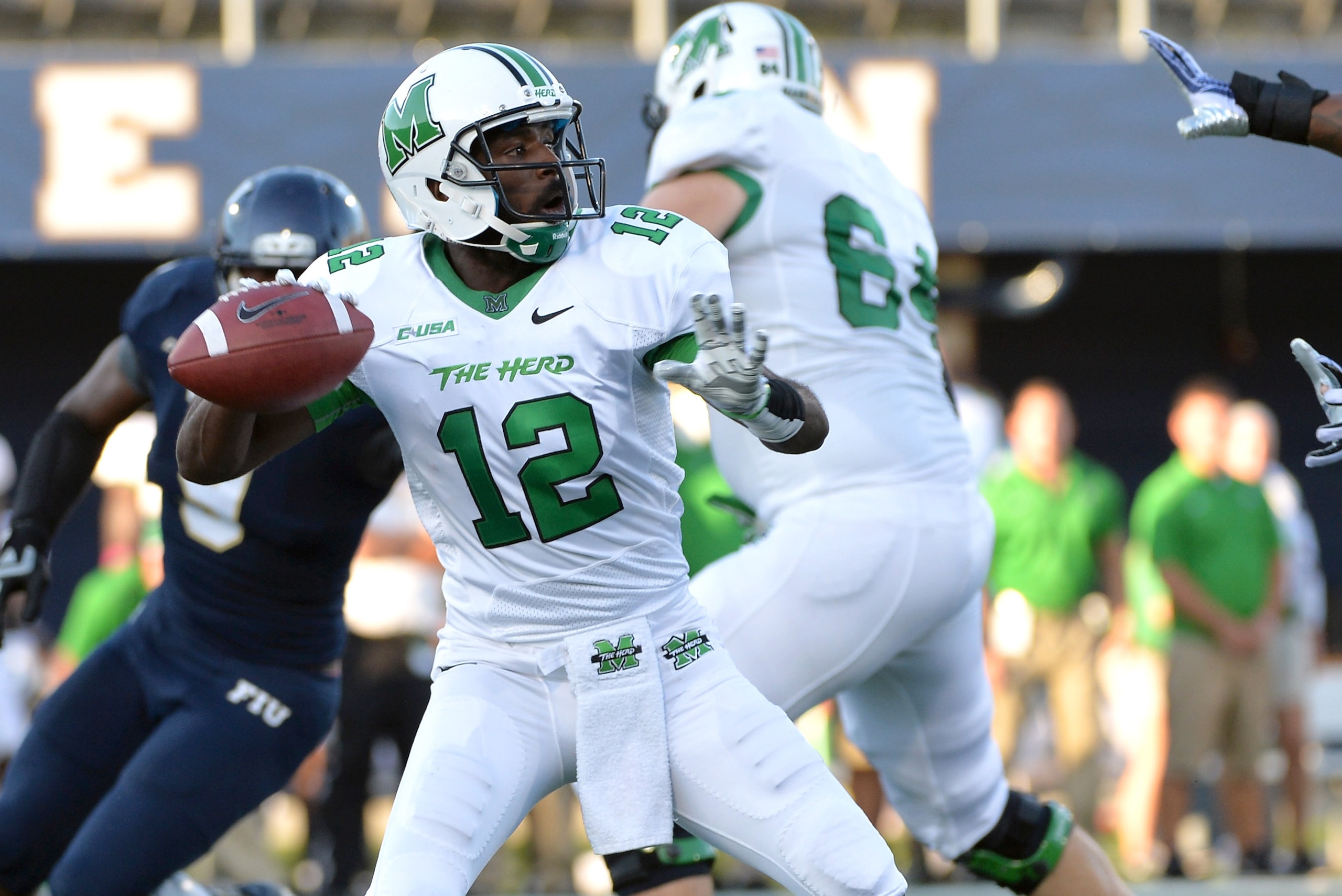 Oct 18, 2014; Miami, FL, USA; Marshall Thundering Herd quarterback Rakeem Cato (12) throws a pass against the Florida International Golden Panthers during the first half at FIU Stadium. Mandatory Credit: Steve Mitchell-USA TODAY Sports