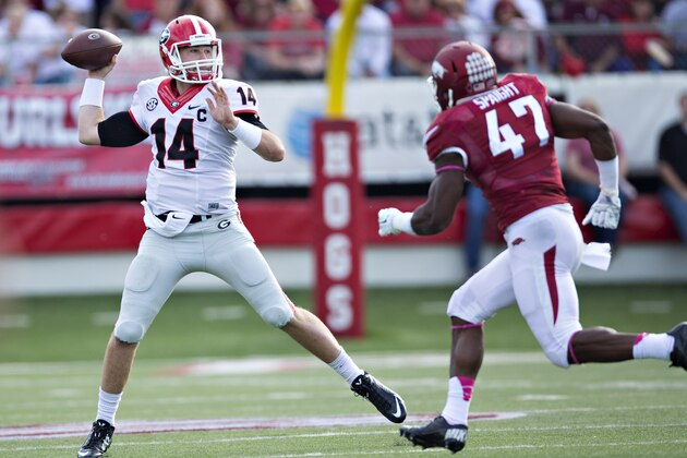 LITTLE ROCK, AR - OCTOBER 18:  Hutson Mason #14 of the Georgia Bulldogs throws a pass under pressure from Martrell Spaight #47 of the Arkansas Razorbacks at War Memorial Stadium on October 18, 2014 in Little Rock, Arkansas.  (Photo by Wesley Hitt/Getty Images)