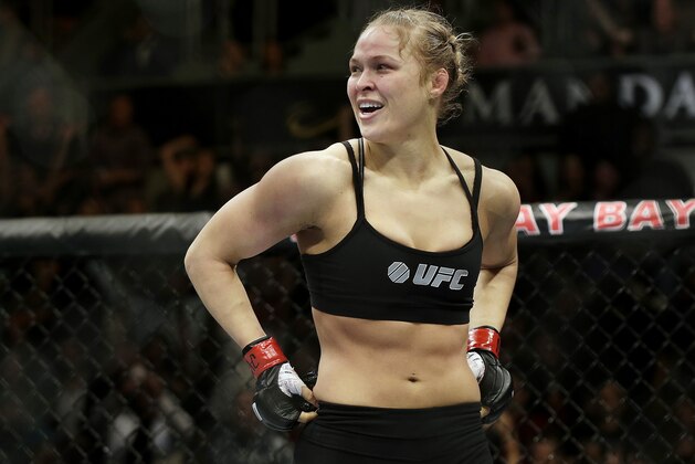 FILE - In this Feb. 22, 2014, file photo, Ronda Rousey looks around after defeating Sara McMann in a UFC 170 mixed martial arts women's bantamweight title bout in Las Vegas. Gina Carano was scheduled to meet with UFC President Dana White on Wednesday April 9, to discuss a return to mixed martial arts for a potential bout with bantamweight champion Rousey. (AP Photo/Isaac Brekken, File)
