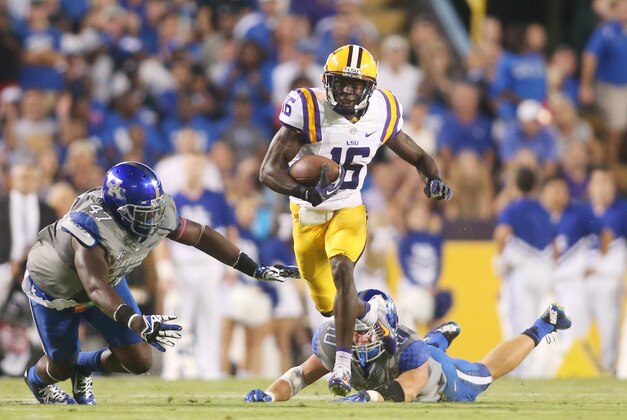 Oct 18, 2014; Baton Rouge, LA, USA; LSU Tigers defensive back Tre'Davious White (16) carries the ball past Kentucky Wildcats linebacker Tyler Brause (behind) and Kentucky Wildcats defensive end Jabari Johnson (47) on a return for a touchdown in the first quarter at Tiger Stadium. Mandatory Credit: Crystal LoGiudice-USA TODAY Sports