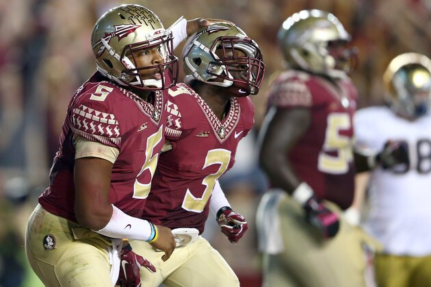 TALLAHASSEE, FL - OCTOBER 18:  Teammates Jameis Winston #5 and Jesus Wilson #3 of the Florida State Seminoles react after a touchdown against the Notre Dame Fighting Irish during their game at Doak Campbell Stadium on October 18, 2014 in Tallahassee, Florida.  (Photo by Streeter Lecka/Getty Images)