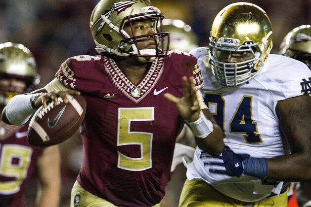 Notre Dame lineman Jarron Jones, right, chases Florida State quarterback Jameis Winson during the second half of an NCAA college football game in Tallahassee, Fla., Saturday, Oct. 18, 2014. Florida State defeated Notre Dame 31-27. (AP Photo/Mark Wallheiser)