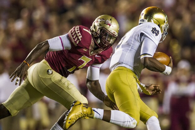 Florida State linebacker Matthew Thomas, left, chases down Notre Dame quarterback Everett Golson in the first half of an NCAA college football game in Tallahassee, Fla., Saturday, Oct. 18, 2014. (AP Photo/Mark Wallheiser)