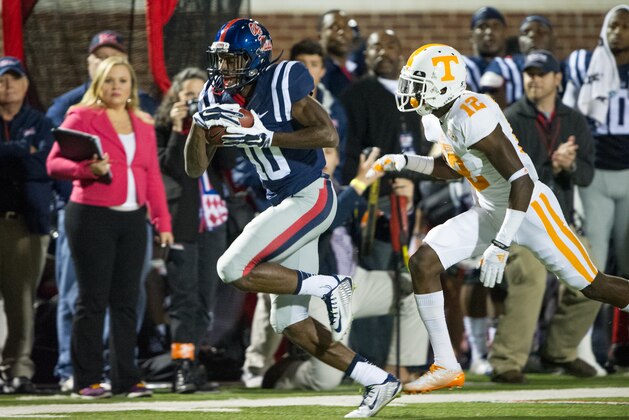 OXFORD, MS - OCTOBER 18: Wide receiver Vince Sanders #10 of the Mississippi Rebels runs the ball down the sidelines in front of defensive back Emmanuel Moseley #12 of the Tennessee Volunteers on October 18, 2014 at Vaught-Hemingway Stadium in Oxford, Mississippi. At halftime the Mississippi Rebels leads the Tennessee Volunteers 14-3. (Photo by Michael Chang/Getty Images)