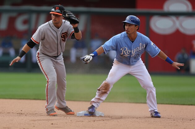 KANSAS CITY, MO - AUGUST 10:  Norichika Aoki #23 of the Kansas City Royals slides into second past Joe Panik #12 of the San Francisco Giants for a steal in the fourth inning at Kauffman Stadium on August 10, 2014 in Kansas City, Missouri. (Photo by Ed Zurga/Getty Images)