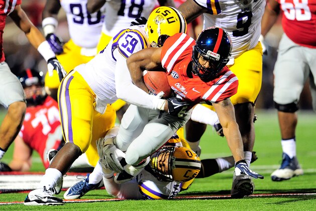 OXFORD, MS - OCTOBER 19:  Jermauria Rasco #59 of the LSU Tigers tackles Jaylen Walton #6 of the Ole Miss Rebels during a game at Vaught-Hemingway Stadium on October 19, 2013 in Oxford, Mississippi.  Ole Miss won the game 27-24.  (Photo by Stacy Revere/Getty Images)