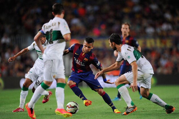 BARCELONA, SPAIN - AUGUST 24:  Dani Alves of FC Barcelona in action during the La Liga match between FC Barcelona and Elche FC at Camp Nou stadium on August 24, 2014 in Barcelona, Spain.  (Photo by Denis Doyle/Getty Images)