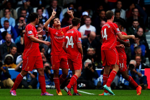LONDON, ENGLAND - OCTOBER 19:  Philippe Coutinho of Liverpool celebrates with team-mates after scoring his team's ssecond goal during the Barclays Premier League match between Queens Park Rangers and Liverpool at Loftus Road on October 19, 2014 in London, England.  (Photo by Clive Rose/Getty Images)