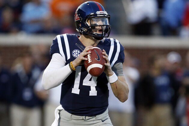 Mississippi quarterback Bo Wallace (14) drops back to pass against Tennessee in the first half of an NCAA college football game in Oxford, Miss., Saturday, Oct. 18, 2014. (AP Photo/Rogelio V. Solis)