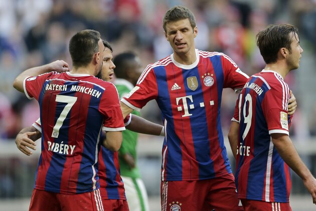 Bayern's Thomas Mueller, center, celebrates after teammate Mario Goetze, right, scored his side's sixth goal during the German first division Bundesliga soccer match between FC Bayern and SV Werder Bremen in the Allianz Arena in Munich, Germany, on Saturday, Oct. 18, 2014. (AP Photo/Matthias Schrader)