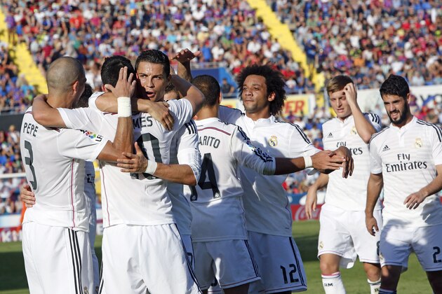 Real Madrid's Isco, is congratulated by teammate Cristiano Ronaldo, from Portugal after scoring a goal against Levante during a Spanish La Liga soccer match at the Ciutat de Valencia stadium in Valencia, Spain, on Saturday, Oct. 18, 2014.(AP Photo/Alberto Saiz)