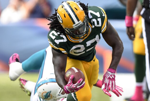 Oct 12, 2014; Miami Gardens, FL, USA; Miami Dolphins outside linebacker Koa Misi (55) brings down Green Bay Packers running back Eddie Lacy (27) in the second quarter of the game at Sun Life Stadium. Mandatory Credit: Brad Barr-USA TODAY Sports