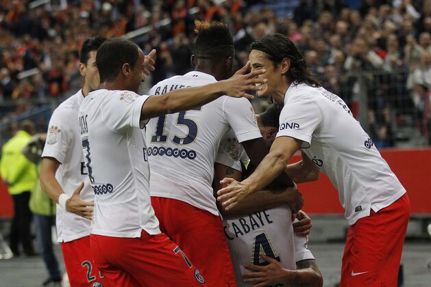 PSG's Lucas, left, and Edinson Cavani, right, celebrate with their teammates after they equalized during their League One soccer match Lens  against Paris Saint Germain at Stade de France stadium in Saint Denis, outside Paris, France, Friday, Oct. 17, 2014. (AP Photo/Michel Euler)
