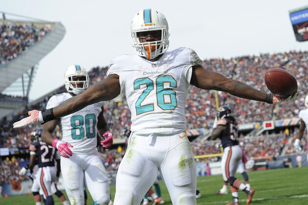 CHICAGO, IL - OCTOBER 19: Lamar Miller #26 of the Miami Dolphins celebrates his touchdown during the third quarter of the game against the Chicago Bears at Soldier Field on October 19, 2014 in Chicago. (Photo by David Banks/Getty Images)