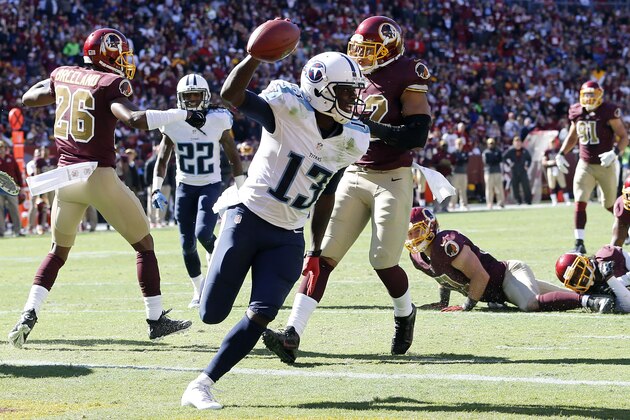 Oct 19, 2014; Landover, MD, USA; Tennessee Titans wide receiver Kendall Wright (13) scores a touchdown in front of Washington Redskins inside linebacker Keenan Robinson (52) in the second quarter at FedEx Field. Mandatory Credit: Geoff Burke-USA TODAY Sports