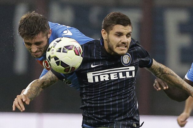 Inter Milan's Mauro Icardi, right, challenges for the ball with NapoliÃ­s David Silva during the Serie A soccer match between Inter Milan and Napoli at the San Siro stadium in Milan, Italy, Sunday, Oct. 19, 2014. (AP Photo/Antonio Calanni)