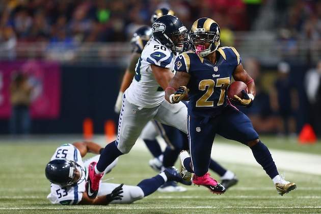 ST. LOUIS, MO - OCTOBER 19: Tre Mason #27 of the St. Louis Rams slips a tackle against K.J. Wright #50 of the Seattle Seahawks in the second quarter at the Edward Jones Dome on October 19, 2014 in St. Louis, Missouri.  (Photo by Dilip Vishwanat/Getty Images)