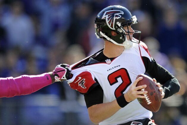 Atlanta Falcons quarterback Matt Ryan tries to break free of Baltimore Ravens outside linebacker Terrell Suggs' grasp as he looks for a receiver in the first half of an NFL football game, Sunday, Oct. 19, 2014, in Baltimore. (AP Photo/Gail Burton)
