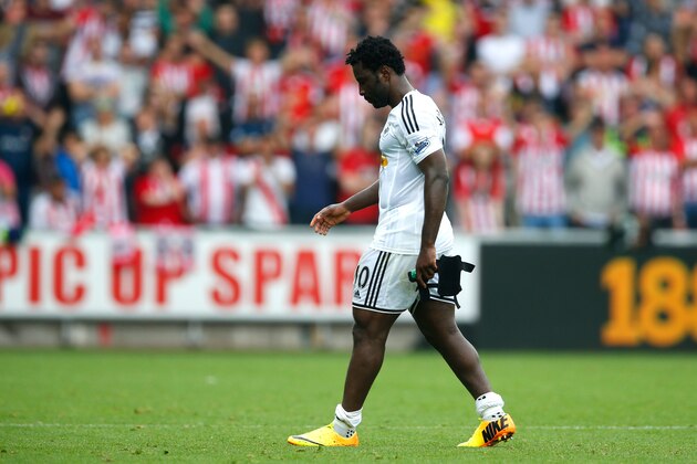 SWANSEA, WALES - SEPTEMBER 20:  Wilfried Bony of Swansea City walks off after being sent off during the Barclays Premier League match between Swansea City and Southampton at Liberty Stadium on September 20, 2014 in Swansea, Wales.  (Photo by Steve Bardens/Getty Images)