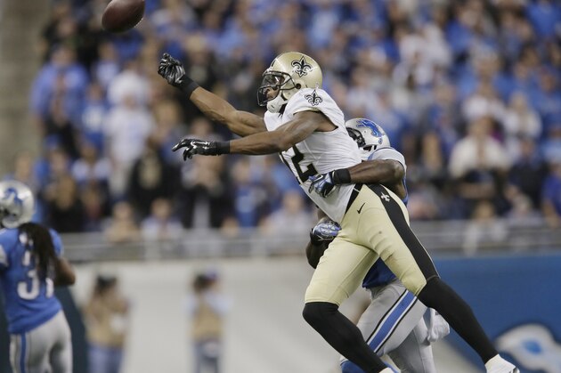 New Orleans Saints wide receiver Marques Colston (12) is defended by Detroit Lions strong safety James Ihedigbo during the second half of an NFL football game in Detroit, Sunday, Oct. 19, 2014. (AP Photo/Duane Burleson)