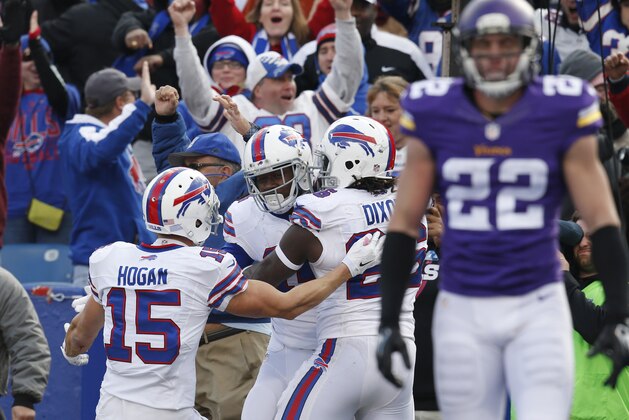 Oct 19, 2014; Orchard Park, NY, USA; Buffalo Bills wide receiver Sammy Watkins (14) is hugged by wide receiver Chris Hogan (15) and running back Anthony Dixon (26) after Watkins scored a touchdown to beat the Minnesota Vikings late in the second half at Ralph Wilson Stadium. Bills beat the Vikings 17-16. Mandatory Credit: Kevin Hoffman-USA TODAY Sports