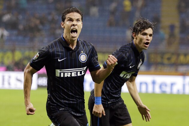 Inter Milan's Anderson Hernanes, left, celebrates with his teammate Inter Milan's Pires Dodo after scoring during the Serie A soccer match between Inter Milan and Napoli at the San Siro stadium in Milan, Italy, Sunday, Oct. 19, 2014. (AP Photo/Antonio Calanni)