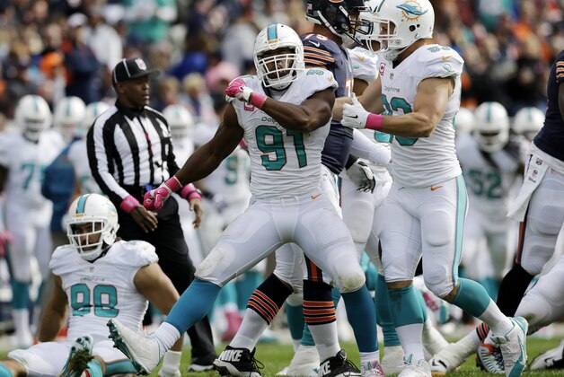 Miami Dolphins defensive end Cameron Wake (91) celebrates after forcing Chicago Bears quarterback Jay Cutler (6) to fumble and then recovering the ball during the second half of an NFL football game Sunday, Oct. 19, 2014 in Chicago. (AP Photo/Nam Y. Huh)