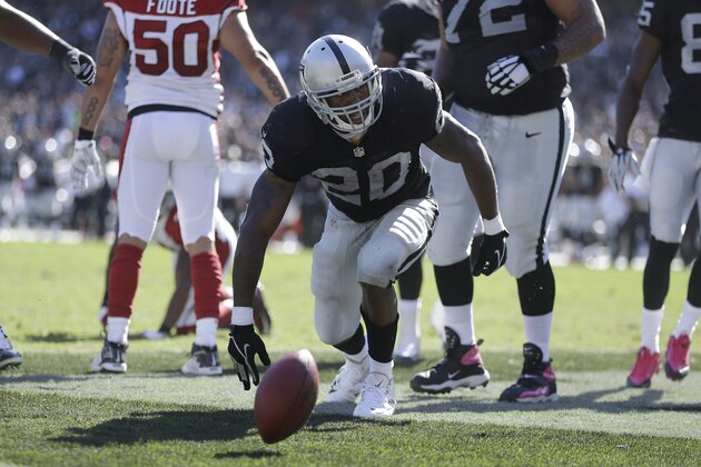 Oakland Raiders running back Darren McFadden celebrates after scoring on a 1-yard touchdown run against the Arizona Cardinals during the second quarter of an NFL football game in Oakland, Calif., Sunday, Oct. 19, 2014. (AP Photo/Ben Margot)