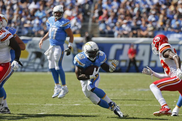 San Diego Chargers running back Branden Oliver moves through the Kansas City Chiefs line during the first half of an NFL football game, Sunday, Oct. 19, 2014, in San Diego. (AP Photo/Lenny Ignelzi)
