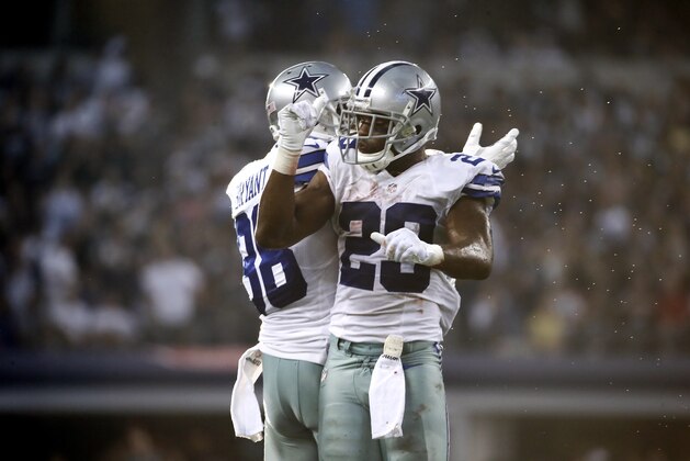 Dallas Cowboys' Dez Bryant (88) and DeMarco Murray (29) celebrate Murray's touchdown run against the New York Giants during the second half of an NFL football game, Sunday, Oct.  19, 2014, in Arlington, Texas. (AP Photo/Brandon Wade)