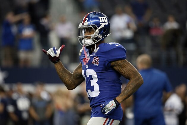 New York Giants wide receiver Odell Beckham gestures as he jogs up field during warm ups before an NFL football game against the Dallas Cowboys, Sunday, Oct., 19, 2014, in Arlington, Texas. (AP Photo/Brandon Wade)