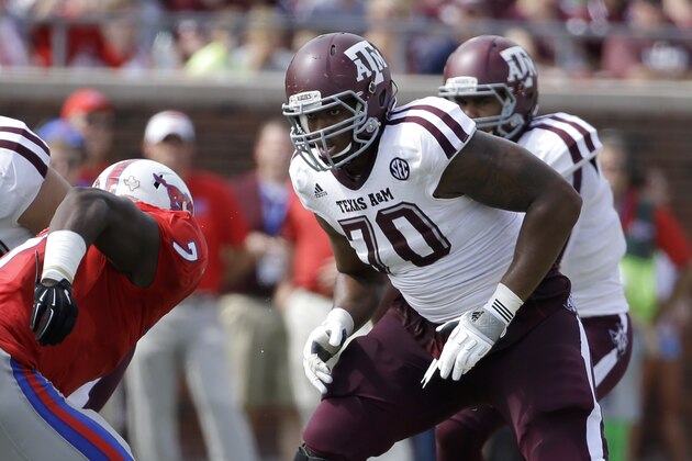 SMU defensive lineman Elie Nabushosi (7) rushes against Texas A&M offensive linesman Cedric Ogbuehi (70) during an NCAA college football game, Saturday, Sept. 20, 2014, in Dallas. (AP Photo/Tony Gutierrez)