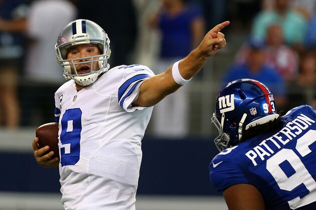 ARLINGTON, TX - OCTOBER 19:  Tony Romo #9 of the Dallas Cowboys signals to a reciever as Mike Patterson #93 of the New York Giants applies pressure in the second half at AT&T Stadium on October 19, 2014 in Arlington, Texas.  (Photo by Ronald Martinez/Getty Images)